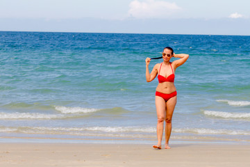 Fototapeta na wymiar Woman shape big with red bikini pretty on beach