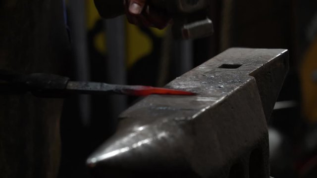Blacksmith making an iron tool