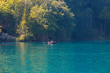 Fototapeta na wymiar boat with people on a lake in the National Park Plitvice Lakes, Croatia