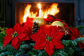 Christmas decoration with the poinsettia flower (Euphorbia pulcherrima), fir, baubles and cones.