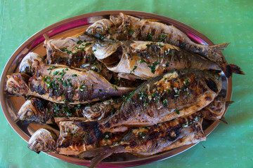 fish cooked on a barbecue on the table
