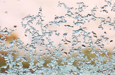 Fototapeta na wymiar window with frozen snowflakes on the glass. Frost on the glass in a frosty morning.