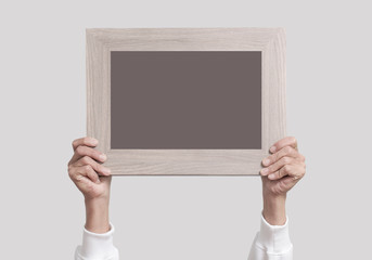 Hand holding frame with gray blank to add text