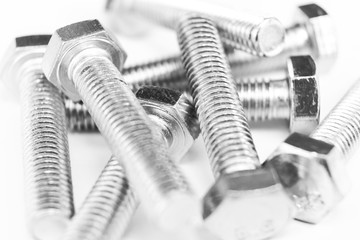 Metal bolts in a row background. Chromed screw bolts isolated. Steel bolts pattern. Set of Nuts and...