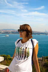 Beautitiful woman traveller standing at the view point to Bosphorus bay in Istanbul Turkey.