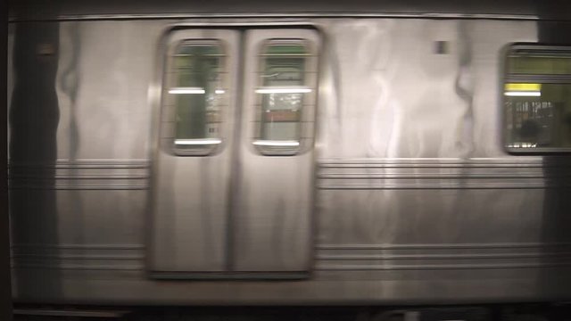 This was taken at a higher frame rate and has been converted to a slow motion video clip. Slow motion of a subway train passing by in the metro station of New York City.