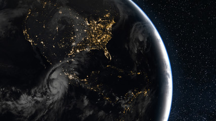View of North and South America from space. City lights and a hurricane over the West coast. View from space. (Elements of this image are provided by NASA) © EvgeniyQW