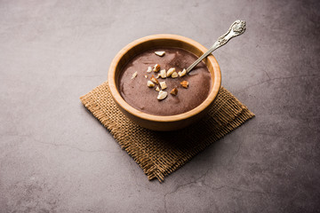 Sweet Ragi Malt / Healthy Ragi Porridge in a bowl garnished with crushed dry fruits