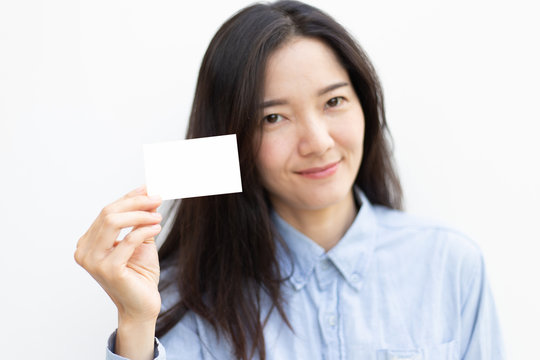 mockup image beautiful young women happy cheerful face smilling.hand holding business card with blank space for text on white background.concept for marketing trade advertisement 