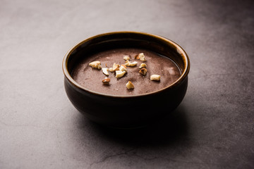 Sweet Ragi Malt / Healthy Ragi Porridge in a bowl garnished with crushed dry fruits