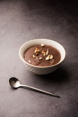 Sweet Ragi Malt / Healthy Ragi Porridge in a bowl garnished with crushed dry fruits