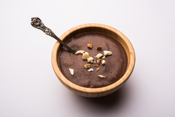 Sweet Ragi Malt / Healthy Ragi Porridge in a bowl garnished with crushed dry fruits