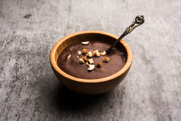 Sweet Ragi Malt / Healthy Ragi Porridge in a bowl garnished with crushed dry fruits