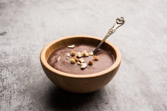 Sweet Ragi Malt / Healthy Ragi Porridge in a bowl garnished with crushed dry fruits