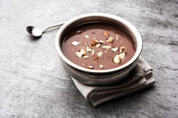 Sweet Ragi Malt / Healthy Ragi Porridge in a bowl garnished with crushed dry fruits