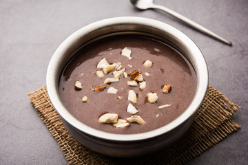 Sweet Ragi Malt / Healthy Ragi Porridge in a bowl garnished with crushed dry fruits