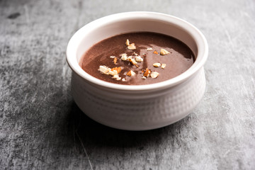 Sweet Ragi Malt / Healthy Ragi Porridge in a bowl garnished with crushed dry fruits