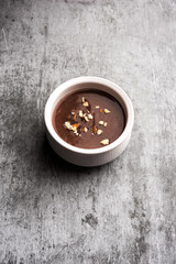 Sweet Ragi Malt / Healthy Ragi Porridge in a bowl garnished with crushed dry fruits