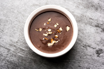 Sweet Ragi Malt / Healthy Ragi Porridge in a bowl garnished with crushed dry fruits