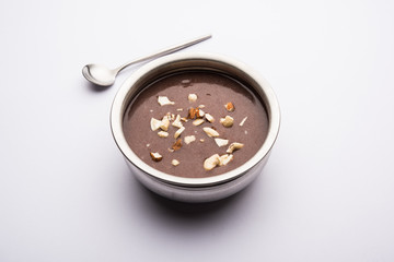 Sweet Ragi Malt / Healthy Ragi Porridge in a bowl garnished with crushed dry fruits