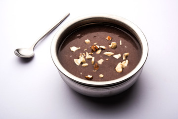 Sweet Ragi Malt / Healthy Ragi Porridge in a bowl garnished with crushed dry fruits