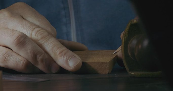 Close-Up Of Male Hands Marking A Wooden Detail With a Pencil For Making A Wooden Beard Comb. Handmade Craftsman Makes A Wooden Comb. Cinema 4K Video