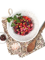 Russian traditional vegetable salad venigret with beets on a white background isolated