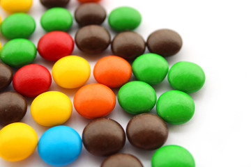 colorful candies on white background, top view
