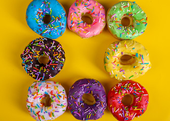 colorful doughnuts yellow background studio
