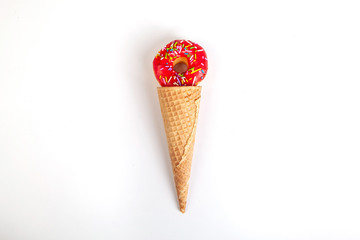 red doughnut in ice cream cone white background