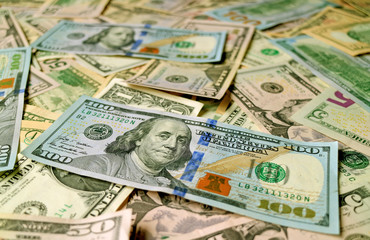 Fototapeta na wymiar Closeup heap of United States dollar bills with selective focus