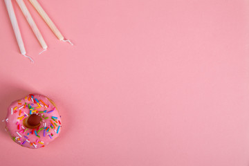 colorful doughnuts candles pink background studio