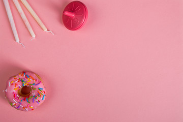 colorful doughnuts dreidel candles pink background studio