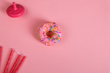 colorful doughnuts dreidel candles pink background studio