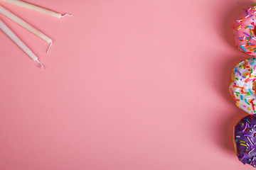 colorful doughnuts candles pink background studio