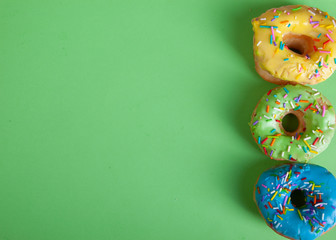 colorful doughnuts green background studio