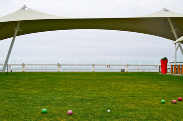 Lawn Club with fresh green gras on Celebrity Cruises modern cruise ship liner to play boules,...