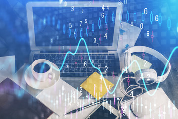 Financial graph colorful drawing and table with computer on background. Double exposure. Concept of international markets.