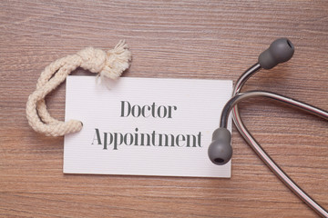 Medical Concept : The words follow up written on price tag label with Stethoscope