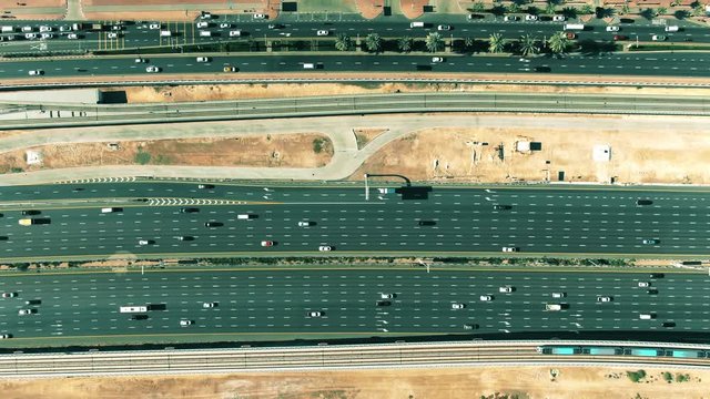 Aerial top down view of a major city road traffic and metro train in Dubai, United Arab Emirates UAE