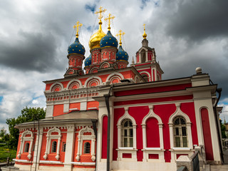 Fototapeta na wymiar Moscow St. George Church in red color and cloudy background