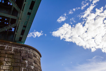 Low angle shot of Hendrix green railway bridge with blue sky and white clouds in Zagreb