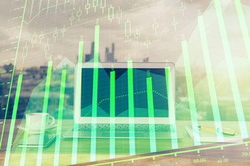 Forex Chart hologram on table with computer background. Multi exposure. Concept of financial...