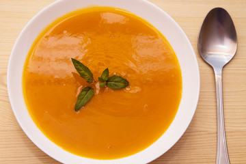 vegetable and carrot soup on background