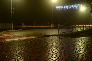 wet tile near the road at night