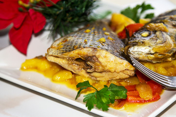 Roasted fish with potatoes for dinner or lunch at Christmas or New Year