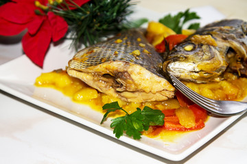 Roasted fish with potatoes for dinner or lunch at Christmas or New Year