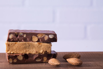 Almond nougat, typical Christmas dessert on wooden background