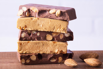 Almond nougat, typical Christmas dessert on wooden background