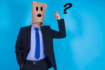 businessman with cardboard bag on his head and question marks